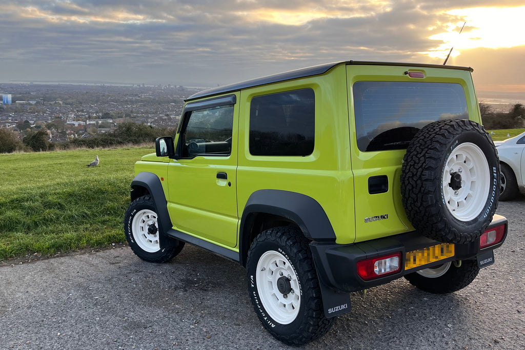 Green Suzuki Jimny with white High Peak J-01 wheels