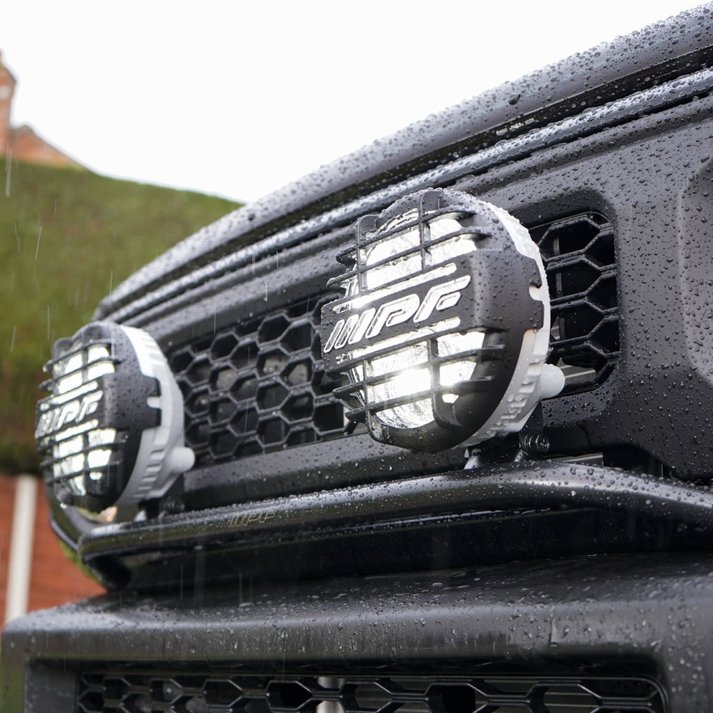 IPF Super Rally LED Spot & Driving Hybrid Lamps with IPF Lamp Stay on a Suzuki Jimny front grille JimnyStyle